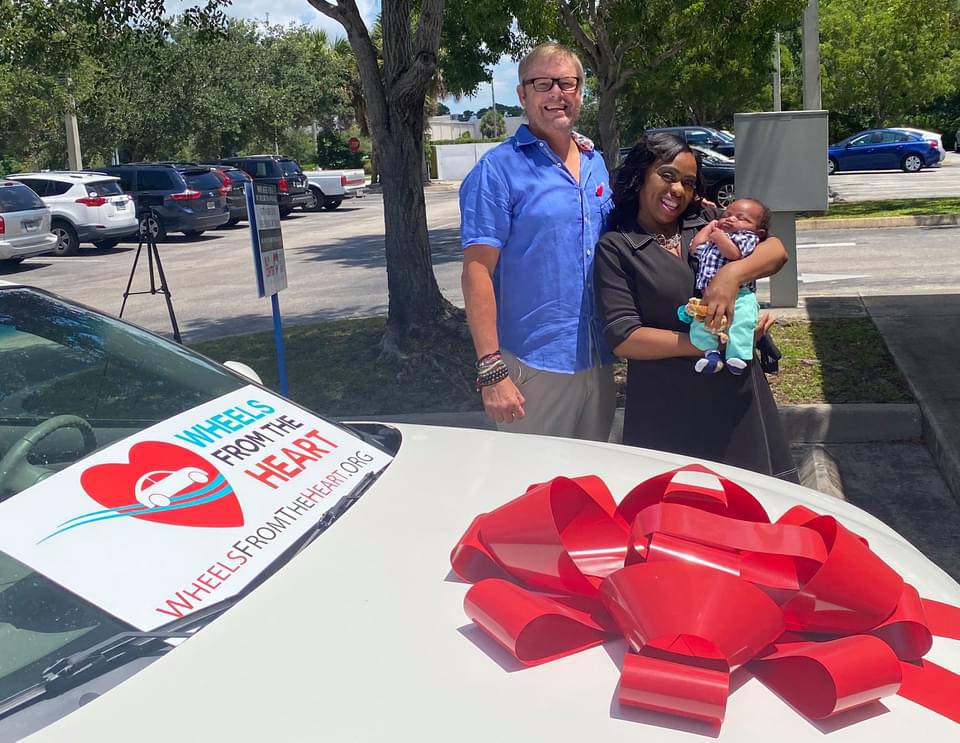 Steve with recipient mother and baby at vehicle donation ceremony